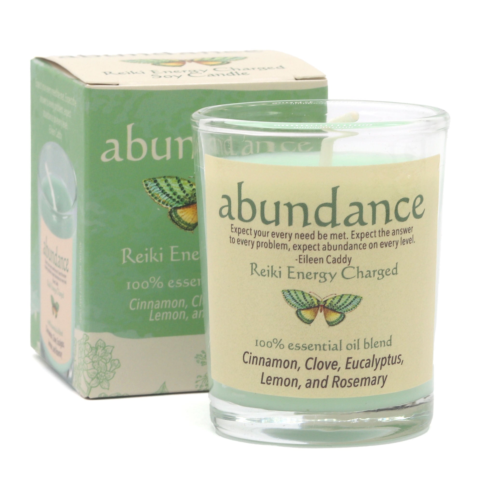 Glass candle with 'abundance' label and packaging on a white background