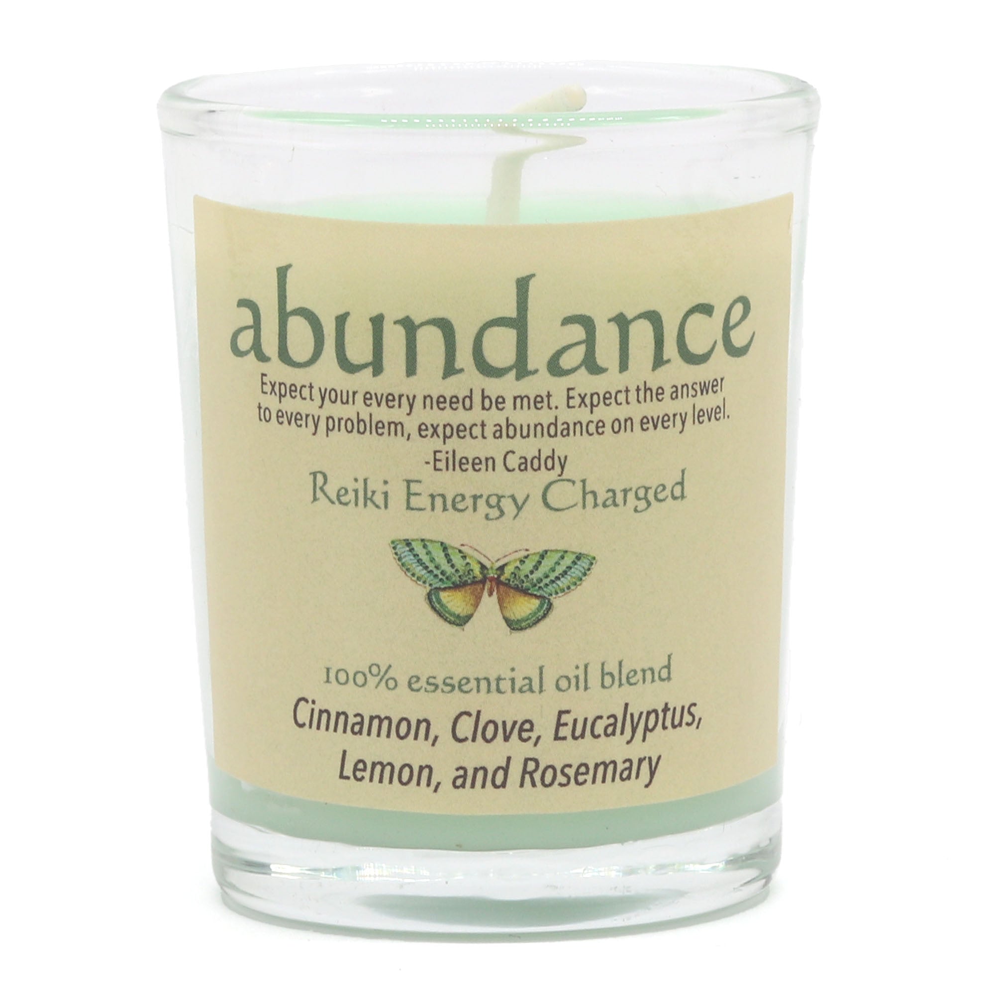 Candle with 'abundance' label and essential oil blend information on a white background