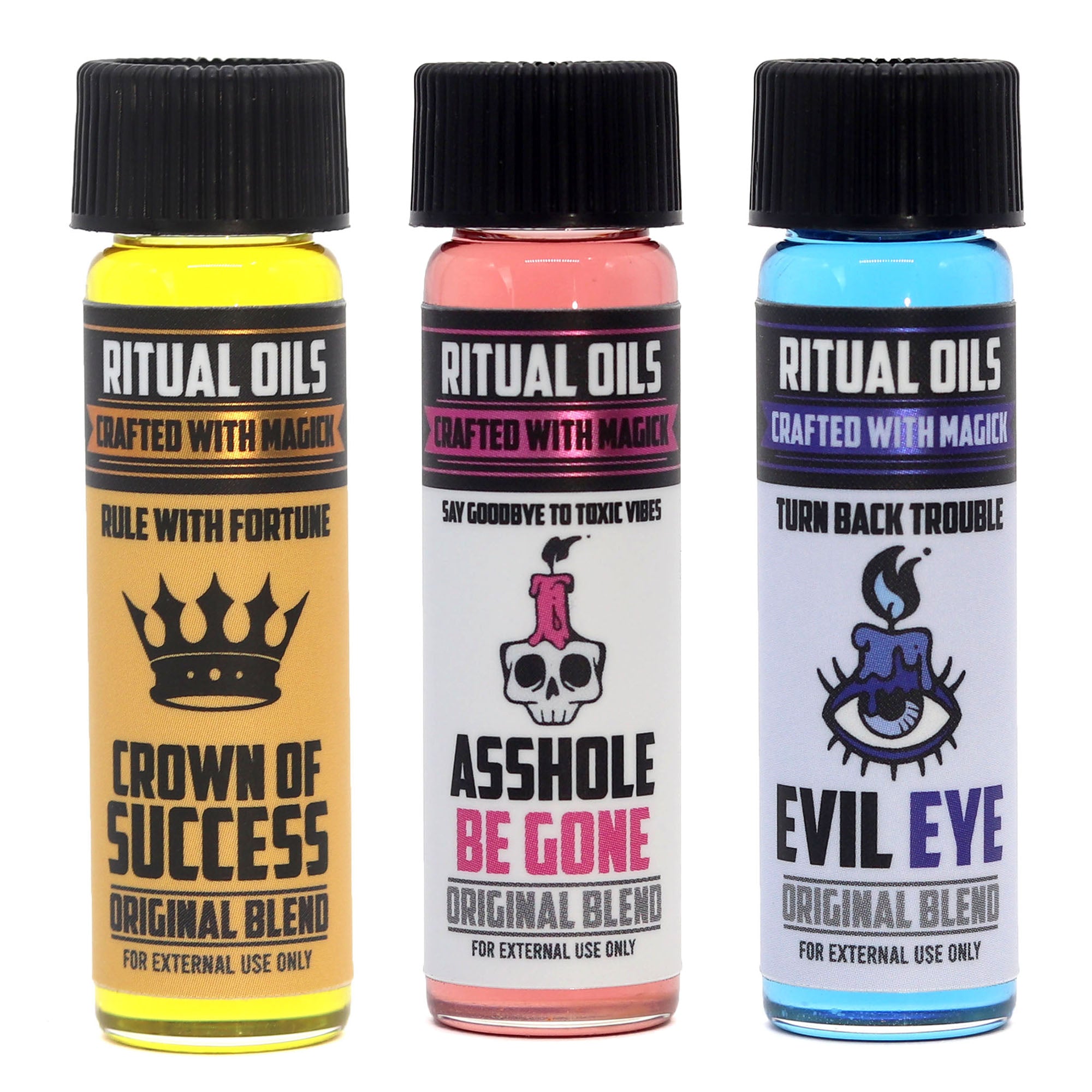 Three bottles of Ritual Oils with different colored liquids and labels on a white background.